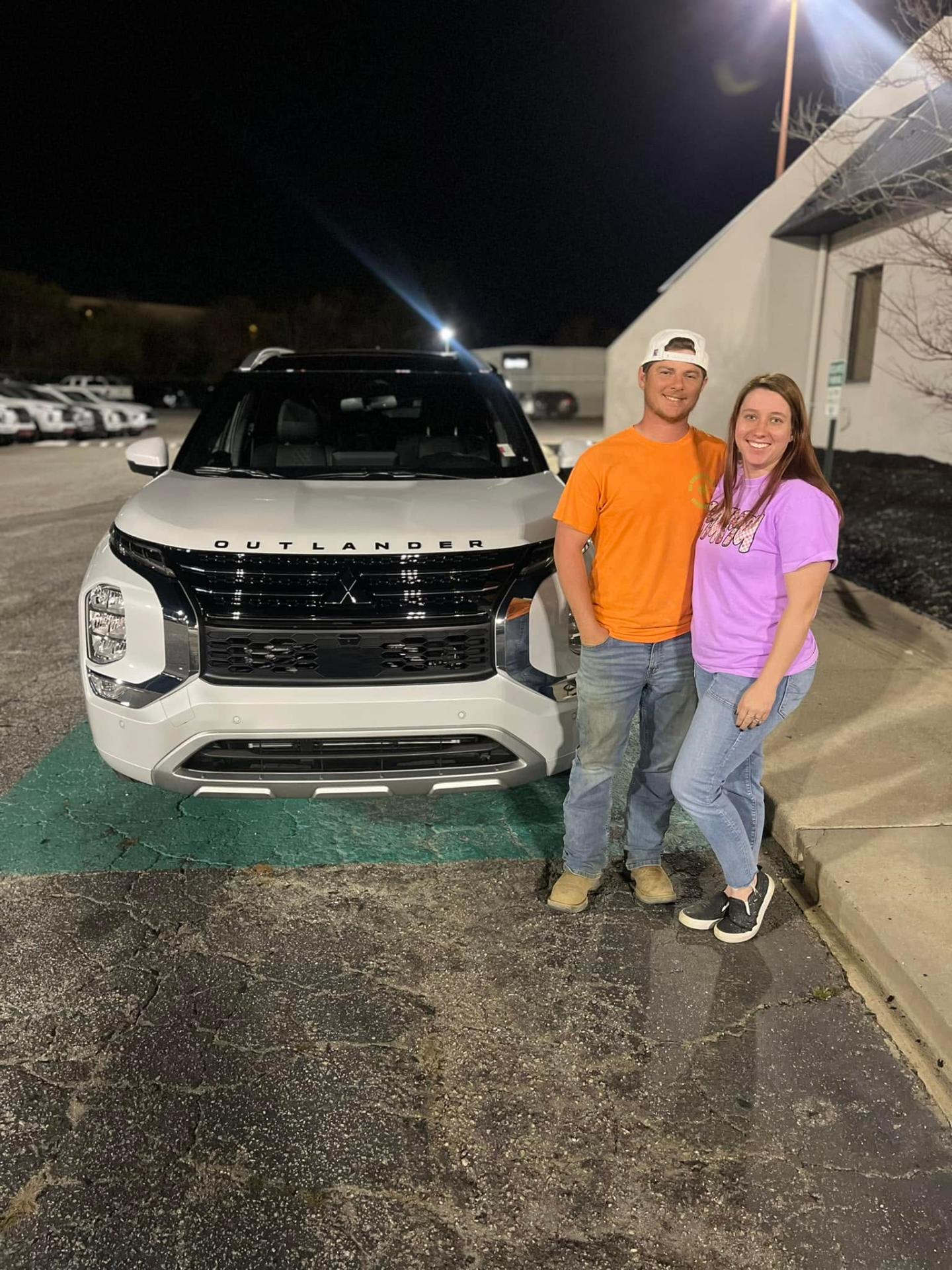 Happy couple with new Mitsubishi Outlander